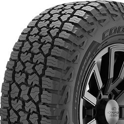 Off-road tire with rugged tread pattern for durability and traction.