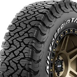 Off-road tire with rugged tread pattern for heavy-duty vehicles.
