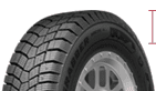 Close-up of a winter tire with deep tread pattern for snow and ice traction.