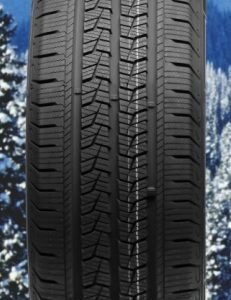 Winter tire with detailed tread pattern for snow and ice conditions.