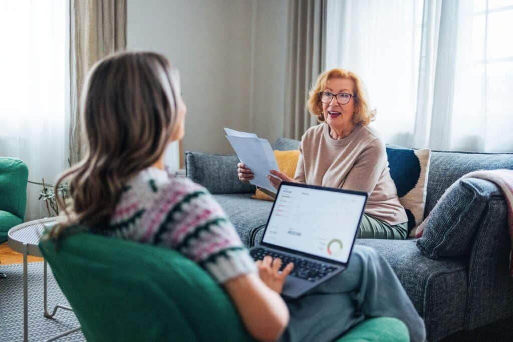Two people discussing a home environment in a calm and supportive setting