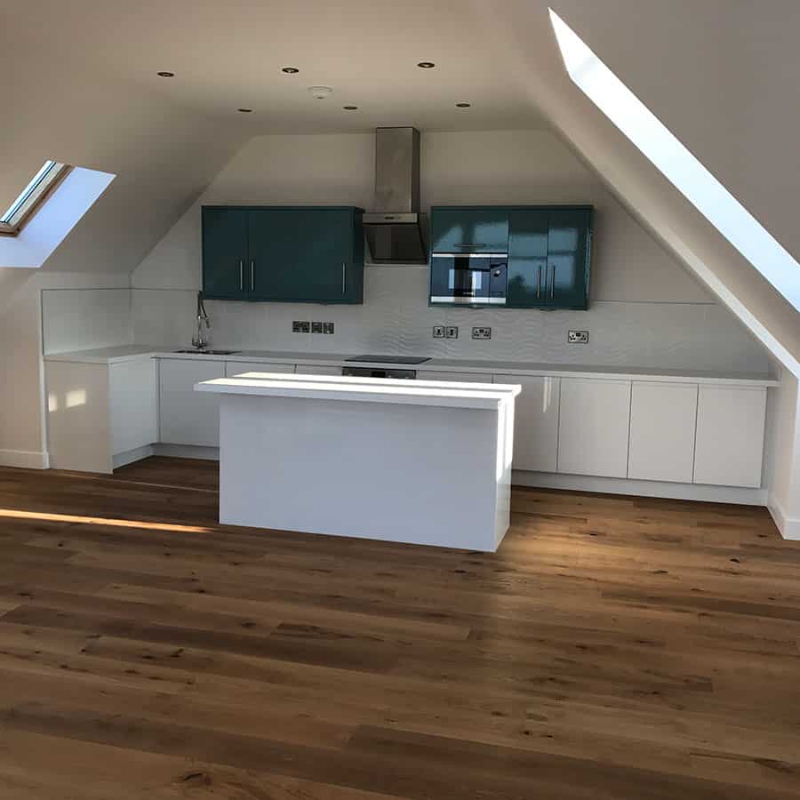 Contemporary kitchen with skylights and sleek cabinetry.