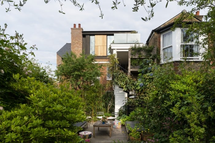 Contemporary home extension with large windows and wooden accents.