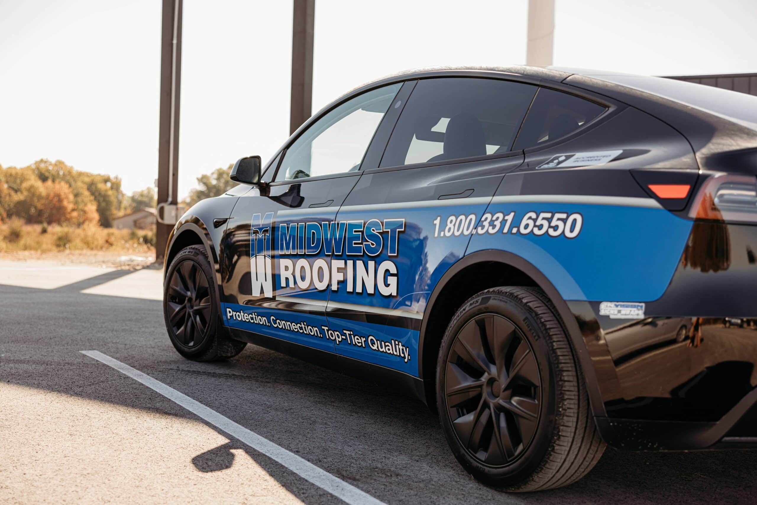 Midwest Roofing vehicle promoting roofing services and career opportunities.