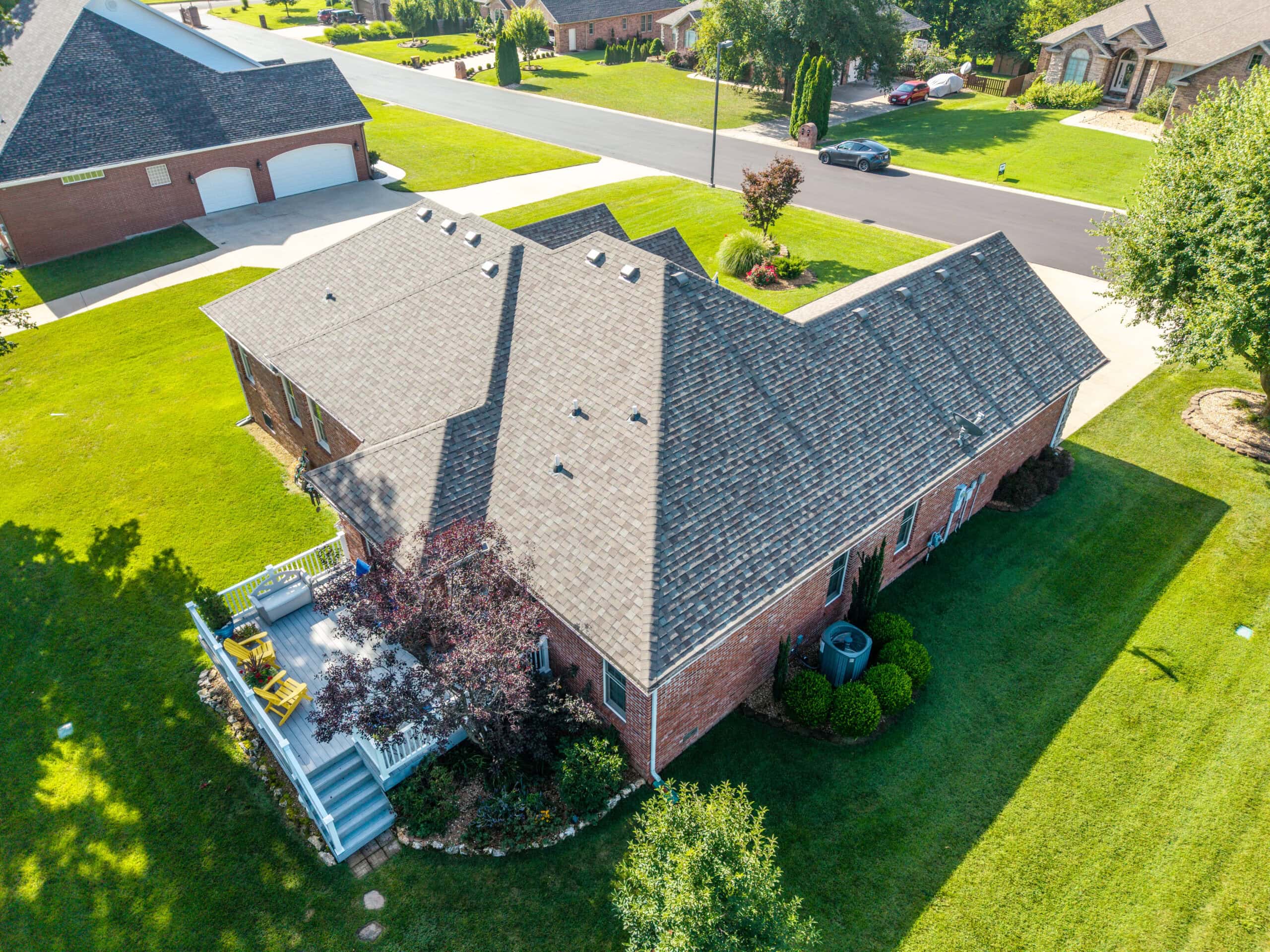Aerial view of a house with new roofing in Lebanon, Missouri.