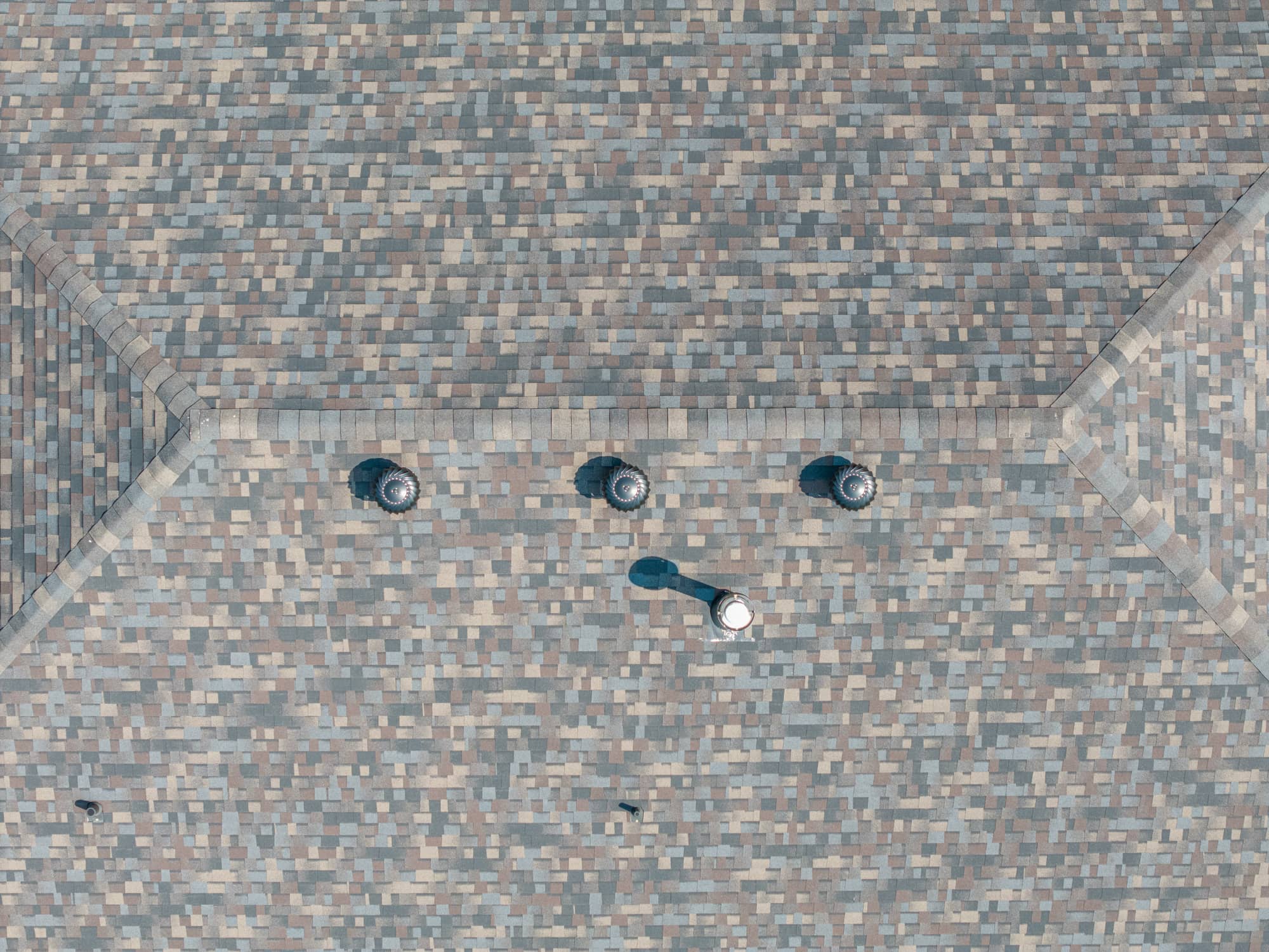 Roof ventilation system with multiple vents on a shingle roof in California, MO.
