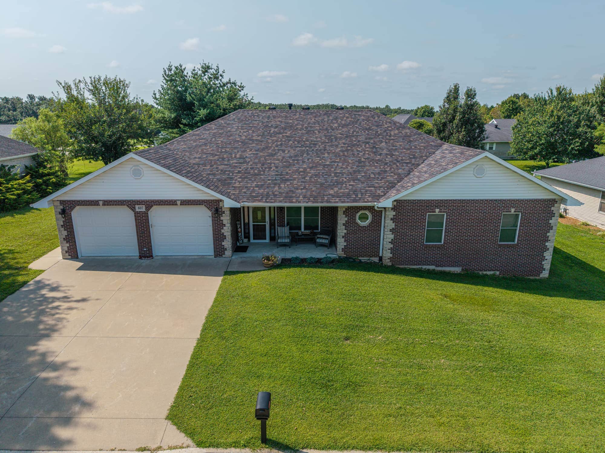 Modern residential roof replacement with new shingles in California, MO.