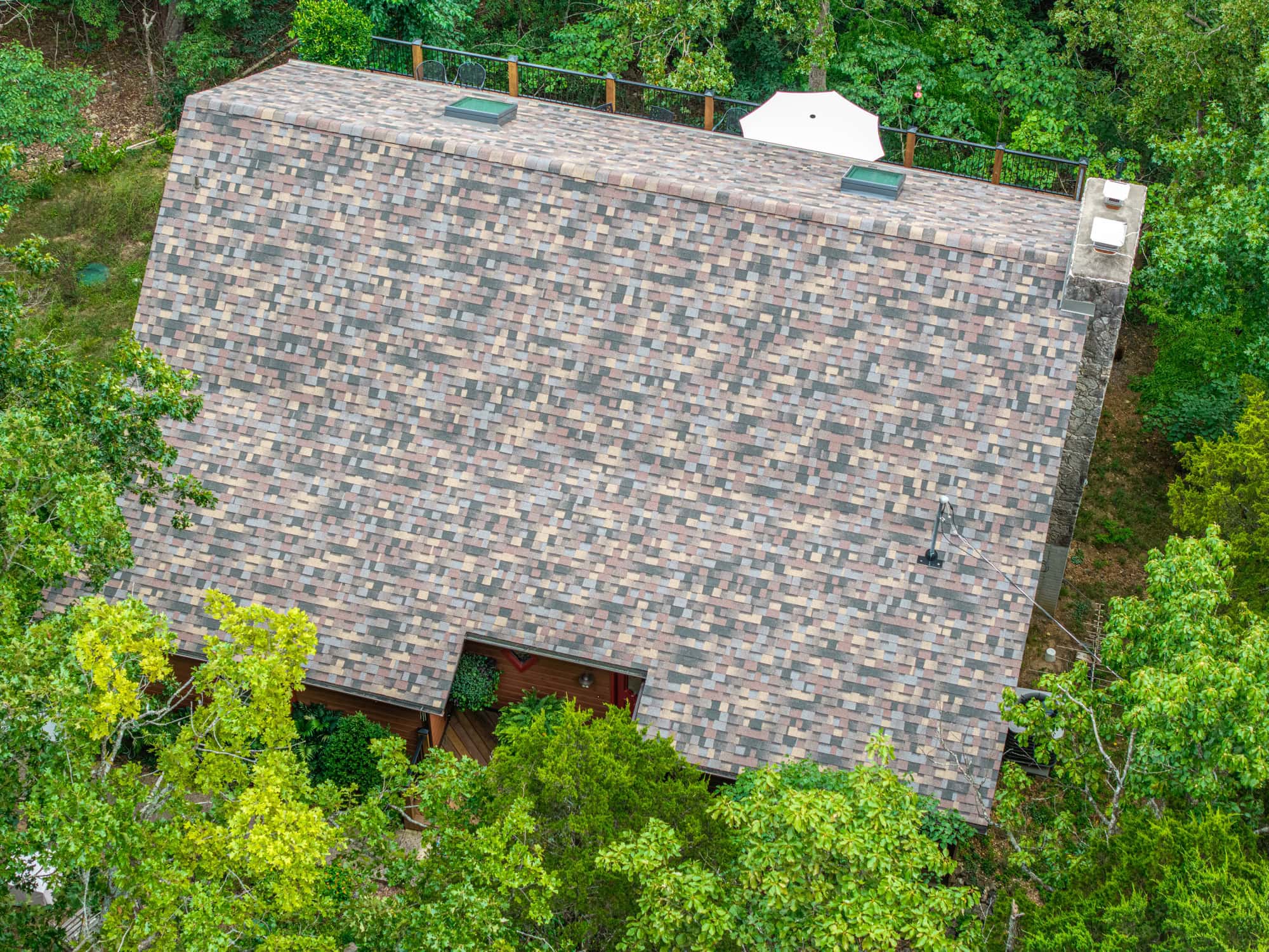 Aerial view of a new asphalt shingle roof on a residential home in Camdenton, Missouri.