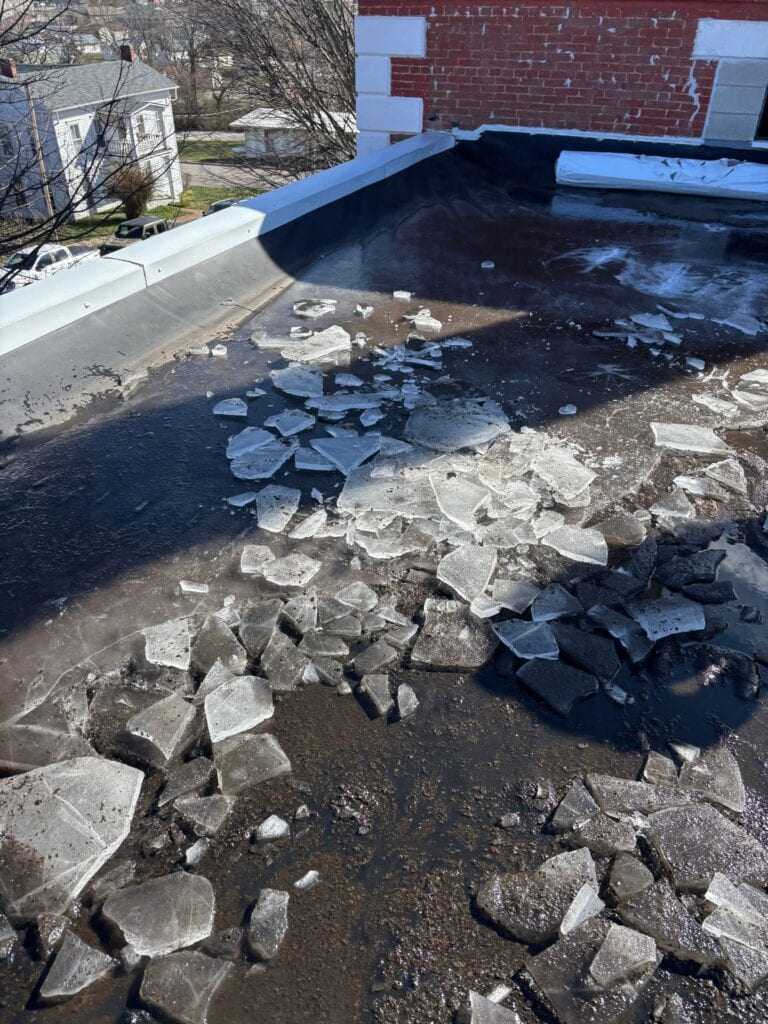 Ice from trapped water on the old flat roof of the historic Phelps County Courthouse building in Rolla