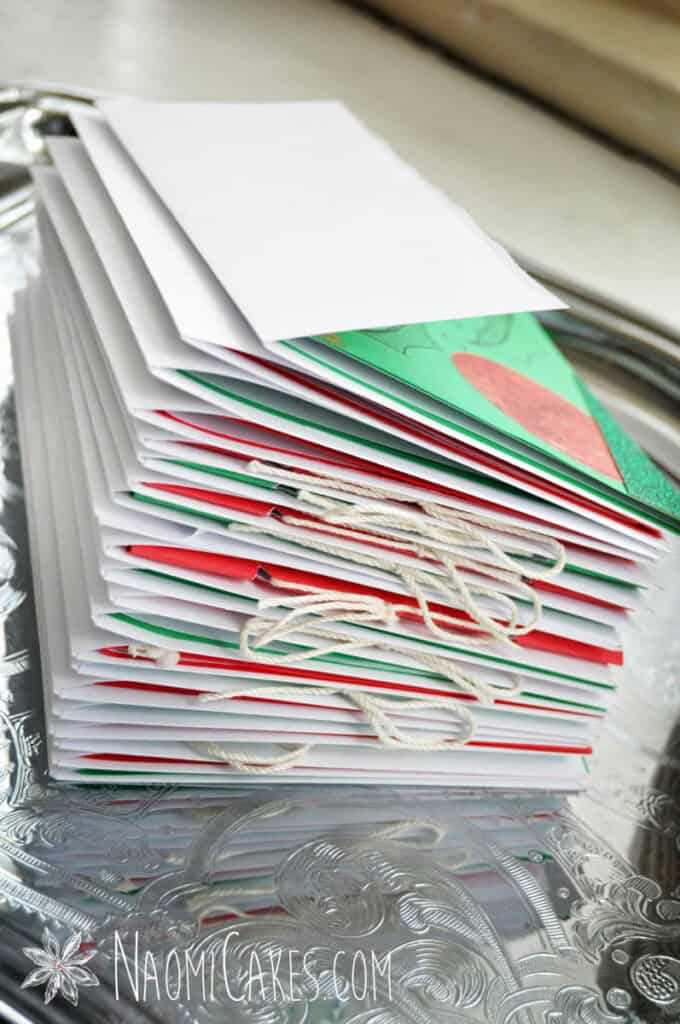 a stack of homemade Christmas cards in white envelopes