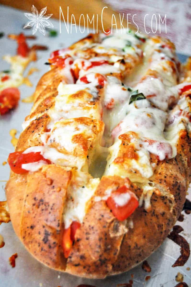 cheesy stuffed garlic bread on a pan