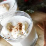 two frosty cups of ice cream punch with cinnamon on top by Christmas decor
