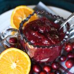 cranberry sauce with orange and cranberries on a plaid napkin