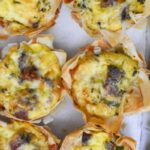miniature quiche tarts with bacon and cheddar on paper towel