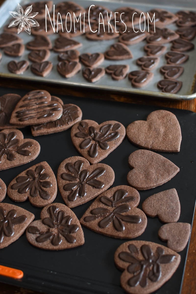 chocolate heart shaped sugar cookies with chocolate decoration on some of them and not on others