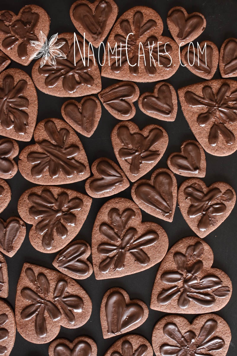 various sized chocolate heart shaped sugar cookies with chocolate smeared on top