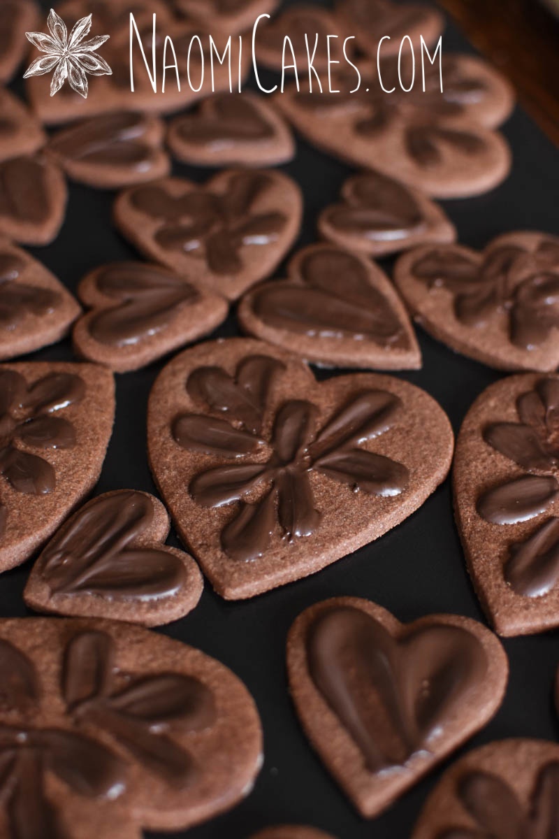 chocolate heart shaped sugar cookies with chocolate smeared on top
