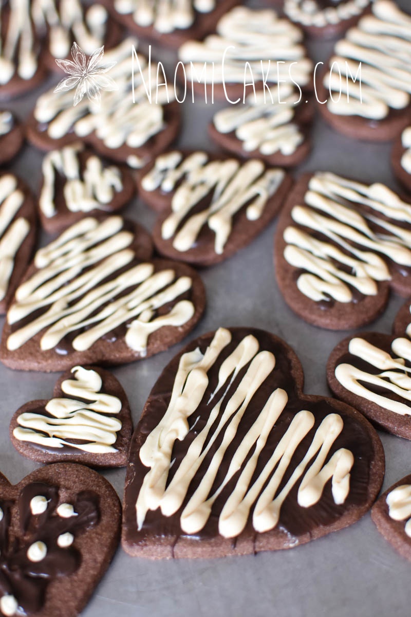 chocolate heart shaped sugar cookies with white and dark chocolate drizzled on top