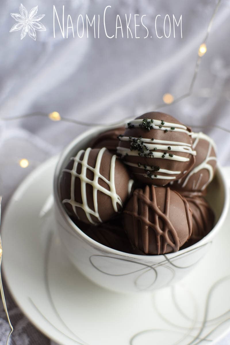 a tea cup with truffles inside with fairy lights in the background