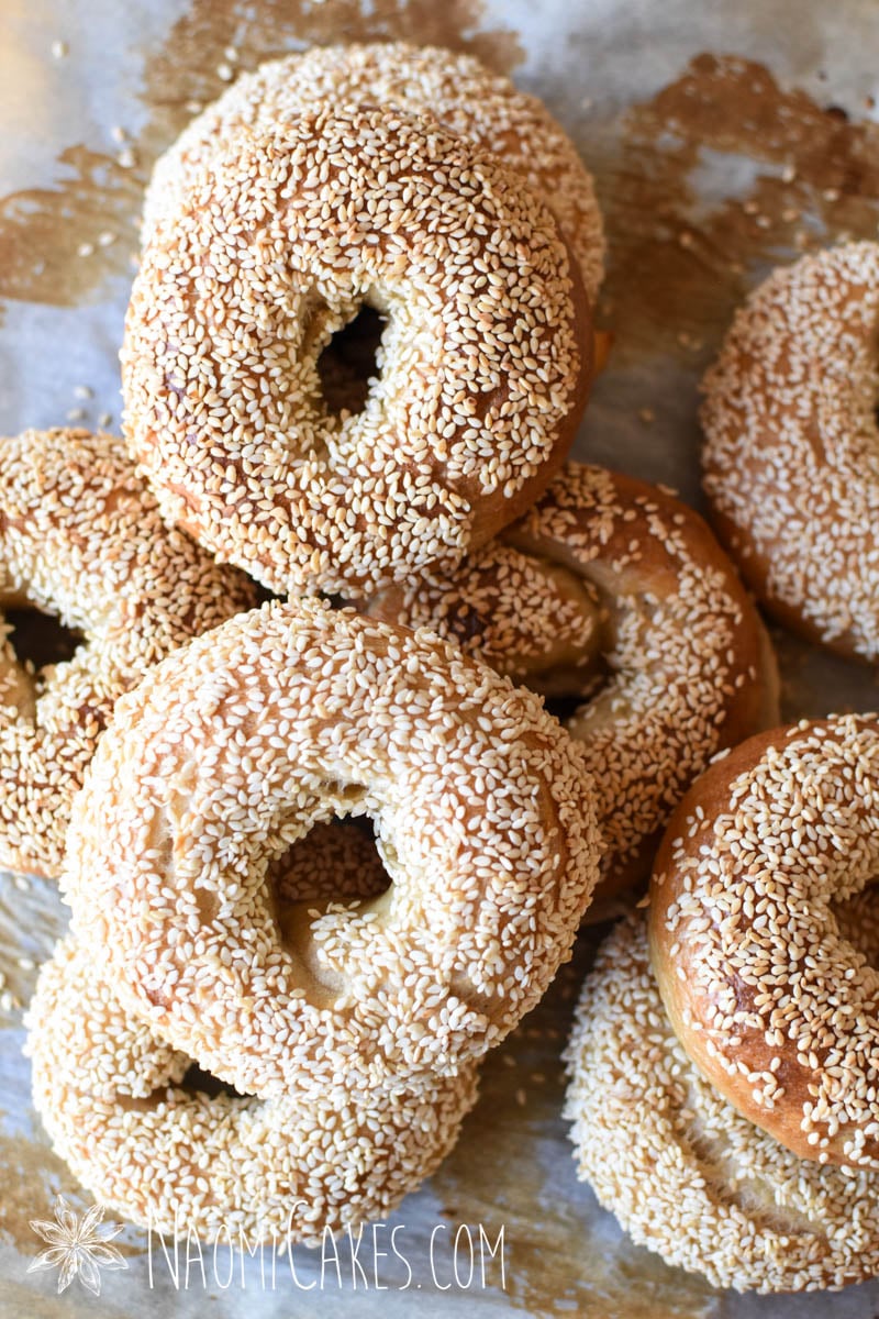 a pile of sesame sourdough bagels