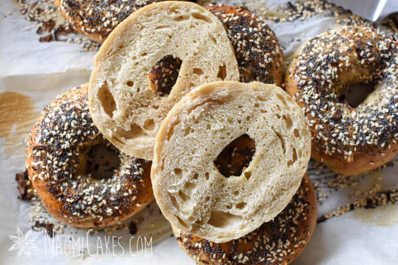 a cut open everything bagel on top of whole bagels