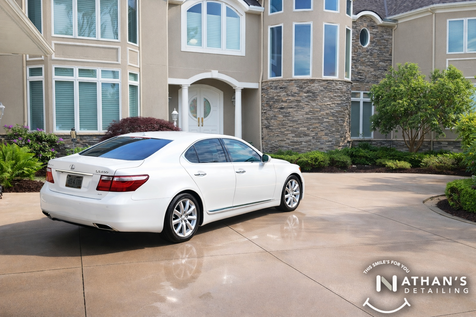 White sedan clean finish in front of home during mobile detailing