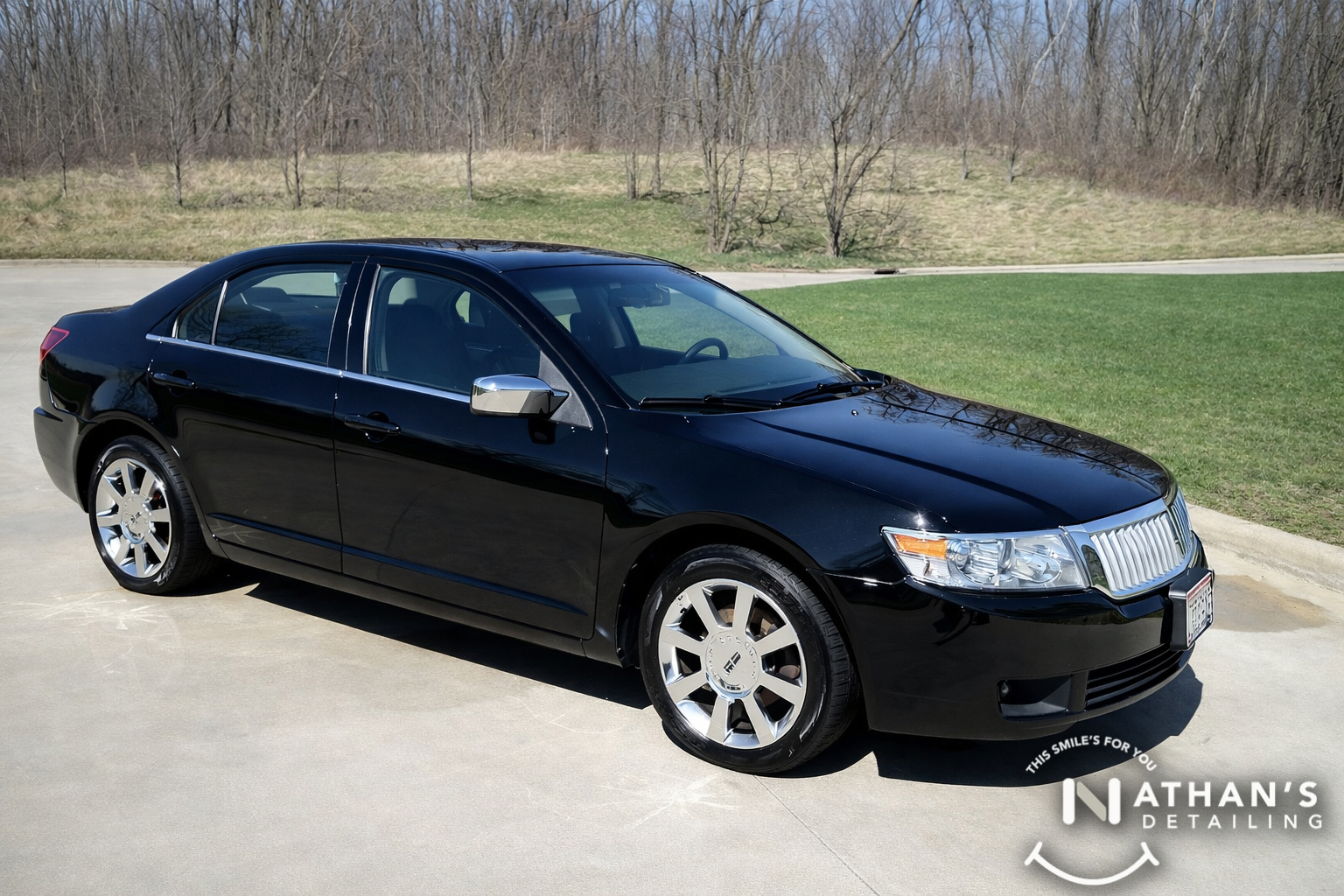 Black luxury sedan cleaned and polished during mobile detailing in Bay Village