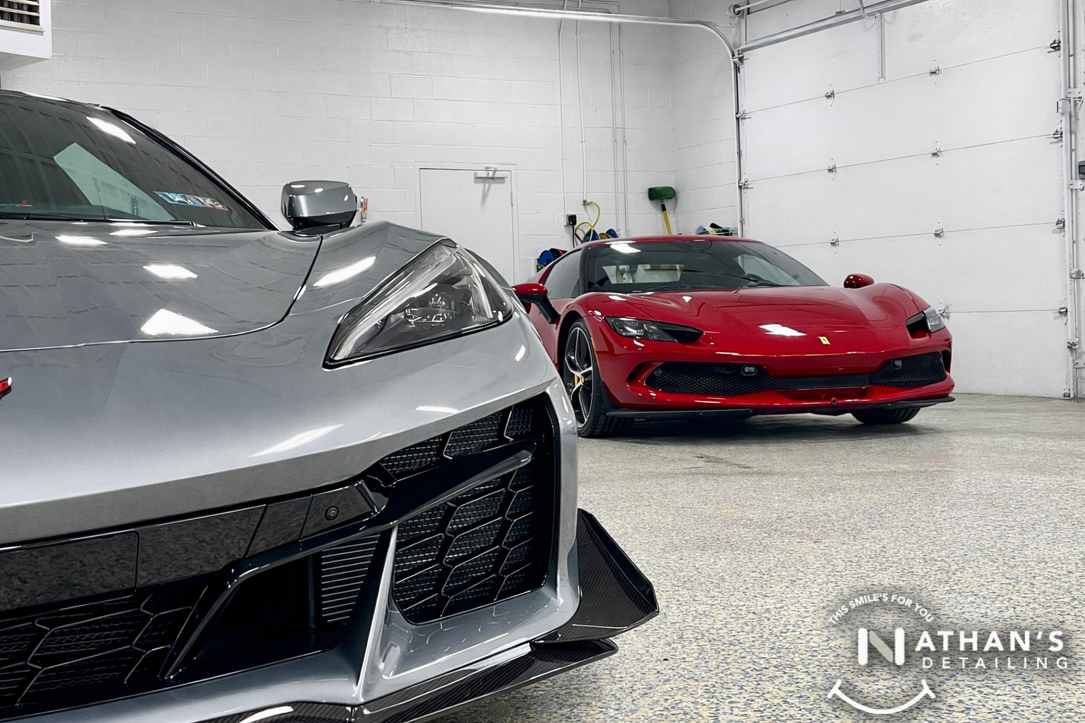 Sports cars lined up in the shop bay after paint protection film service.