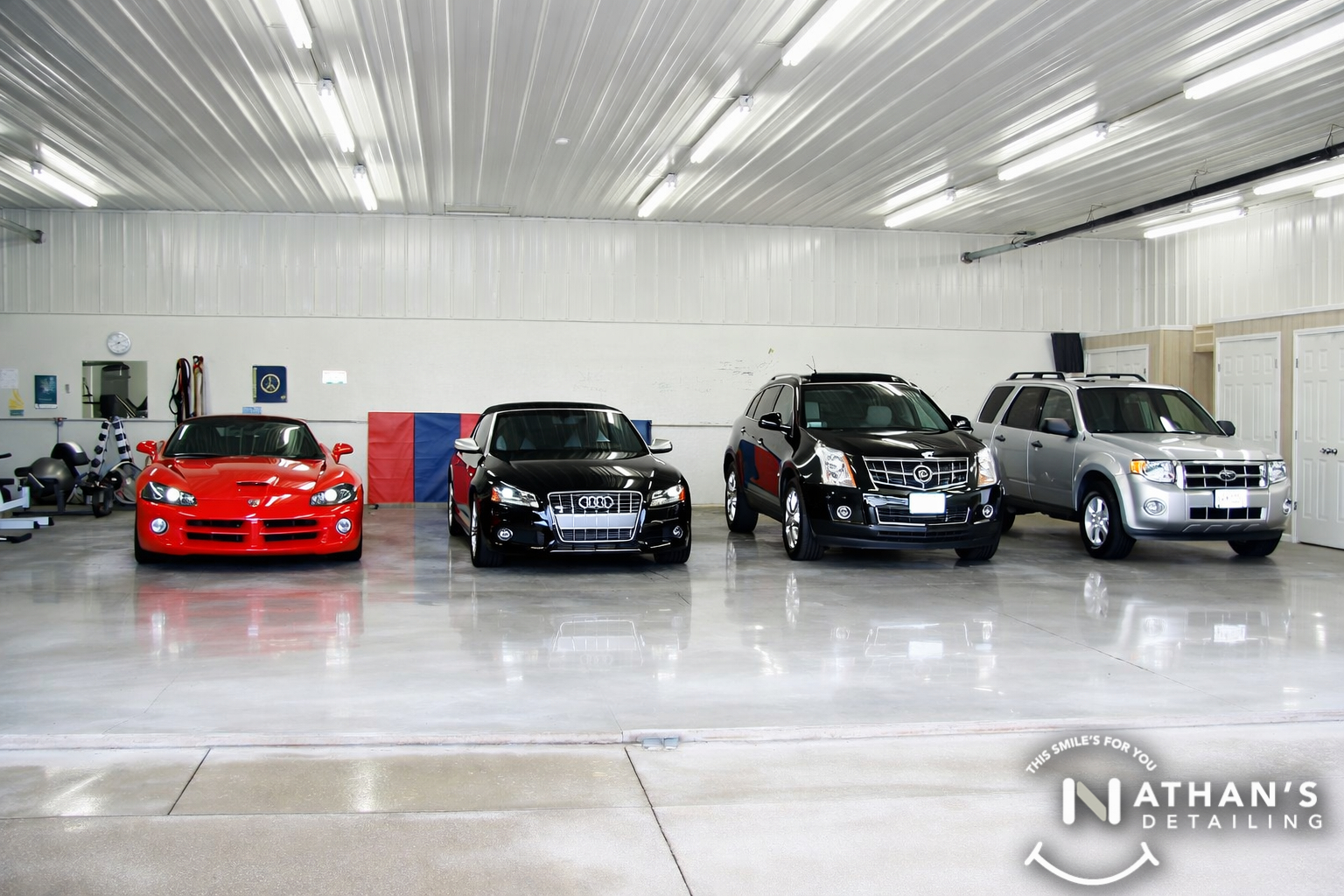 Vehicles lined up in indoor detail bay during mobile detailing