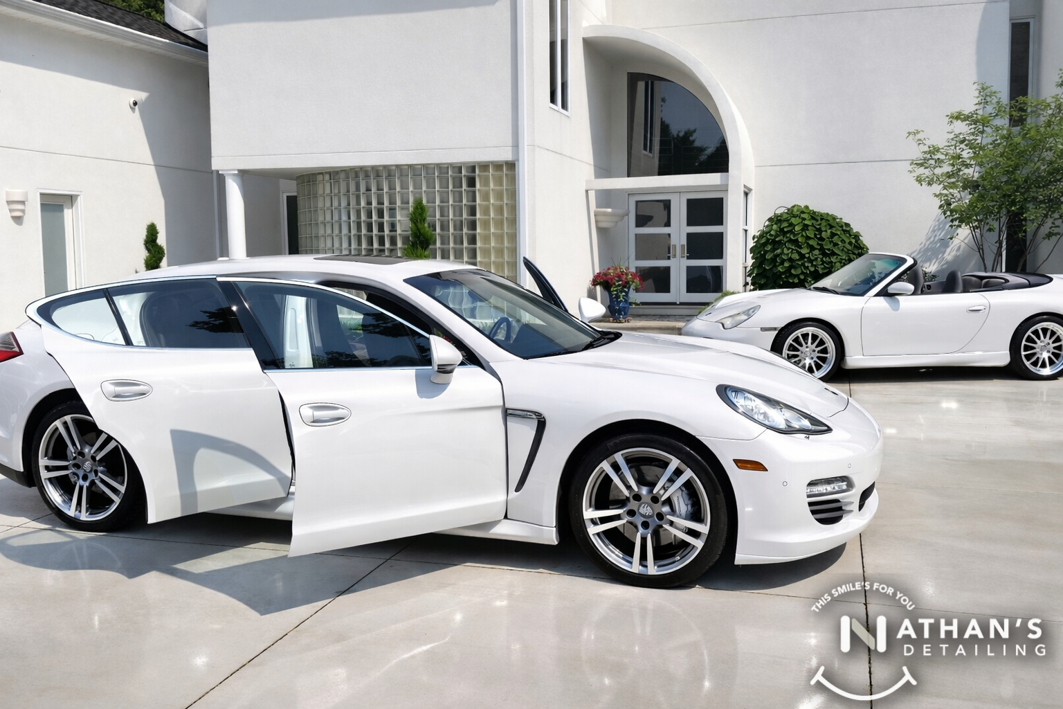 White sedan shine with driver door open during mobile detailing in Euclid