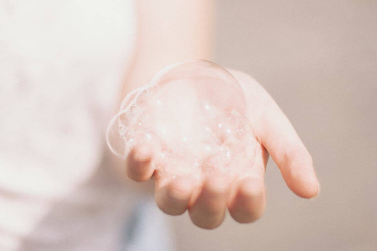 Person examining their skin in the mirror - seborrhoeic dermatitis skincare