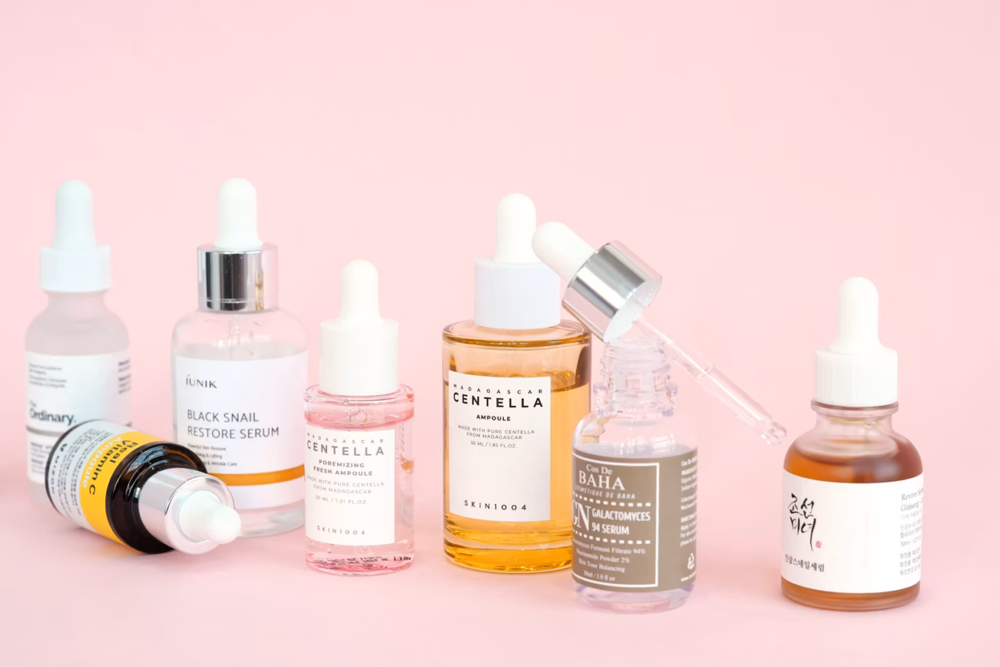 Flatlay of Korean skincare (K-beauty) products arranged on a pink background for the Stylevana flash sale