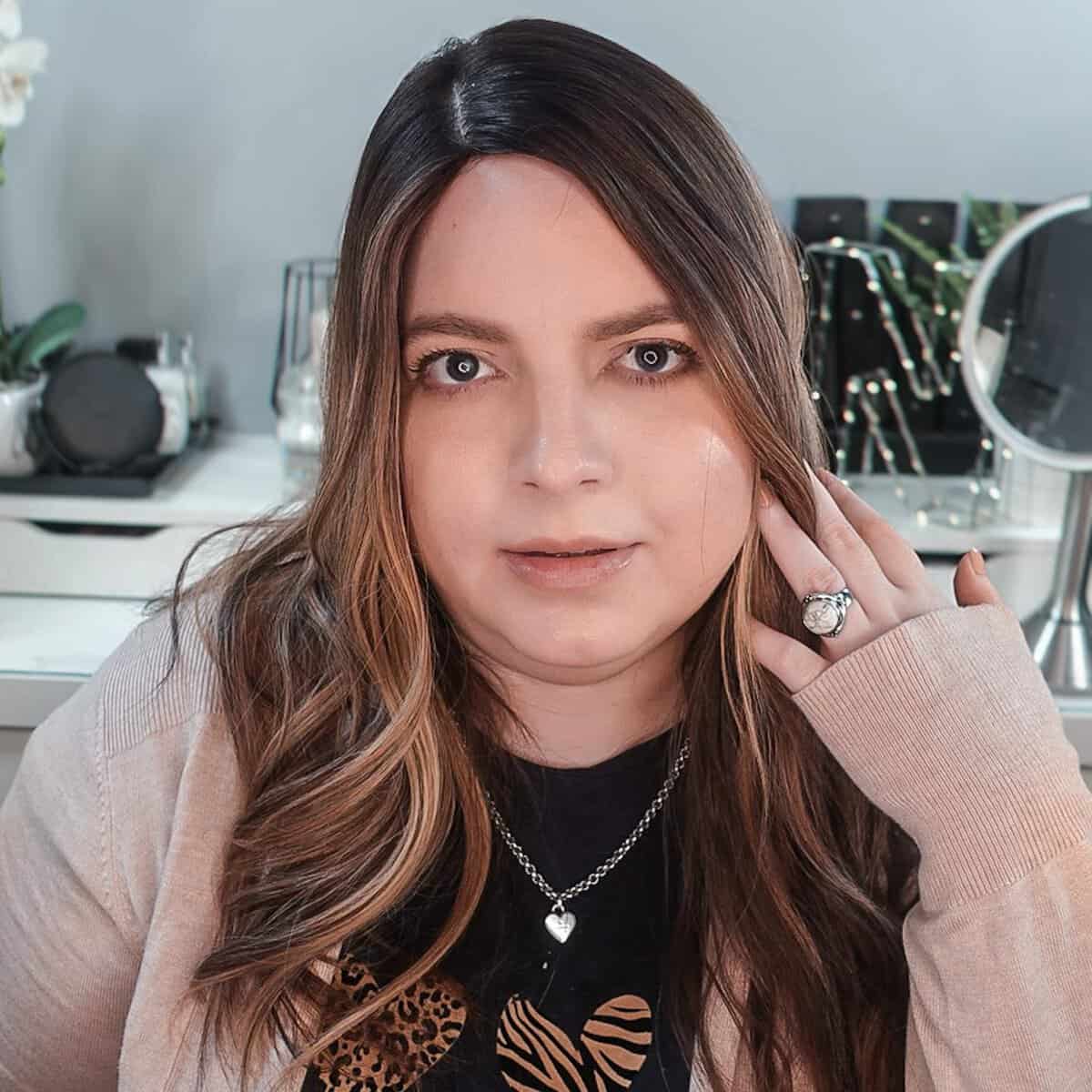 Neveen Wood wearing the Highline Light Lexie Dark Root hair topper, 7x8 silk top
