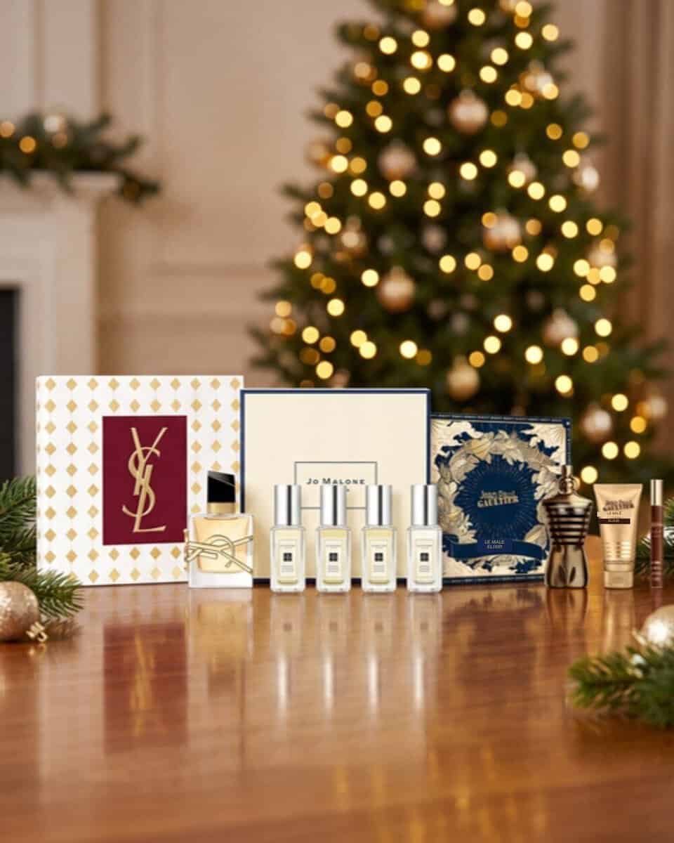 Perfume gift sets for Christmas 2026 including YSL Libre, Jo Malone and Jean Paul Gaultier Le Male on a festive table