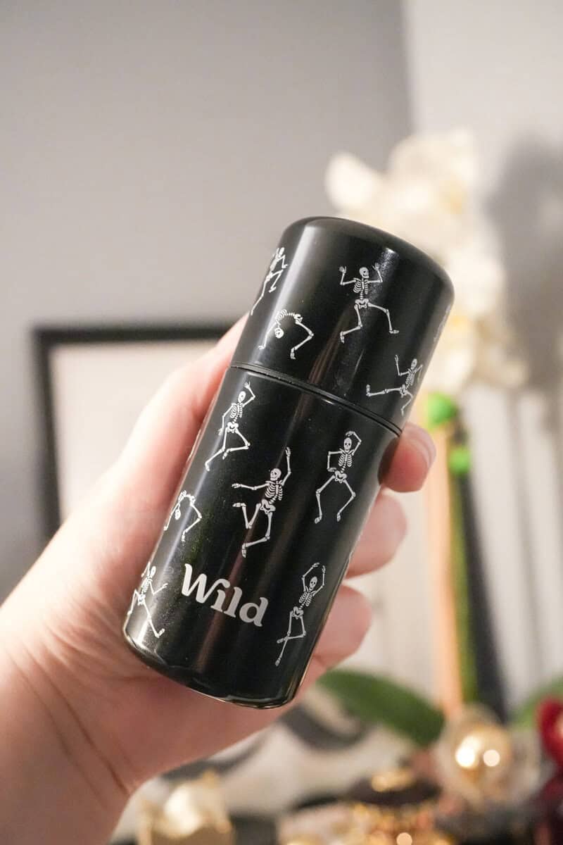 Holding the Wild dancing skeleton Halloween deodorant case