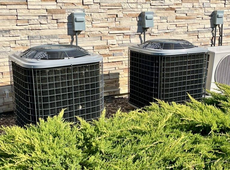 Keeping it cool—outdoor air conditioning units working hard against the summer heat.