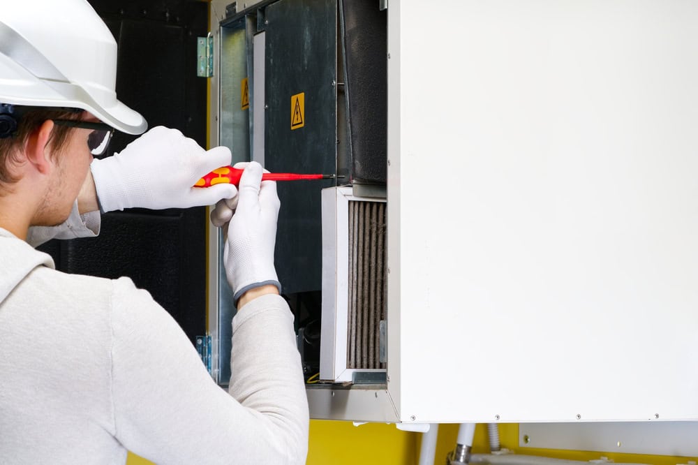 Engineer performing maintenance on an industrial electrical panel.