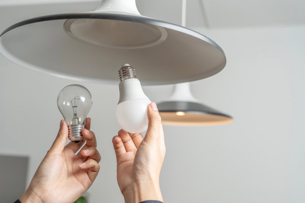 Switching to efficiency—replacing an old incandescent bulb with a modern LED.