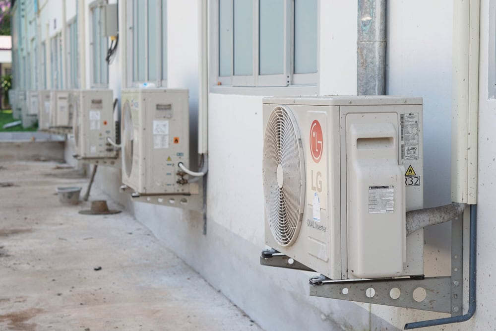 Row of LG air conditioning units mounted on the exterior wall of a building.
