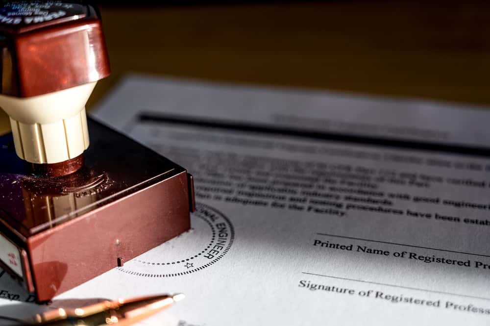 Official seal and signature in progress on a professional engineering certification document.