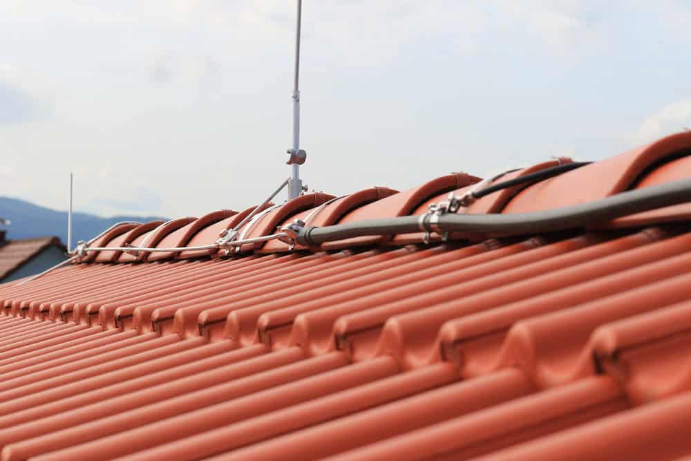 Lightning protection system installed on a terracotta-tiled roof, ensuring safety during storms.