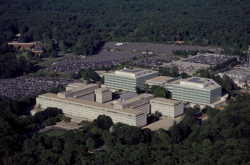 Aerial view of the CIA headquarters complex surrounded by woodland and parking areas in Langley, Virginia.