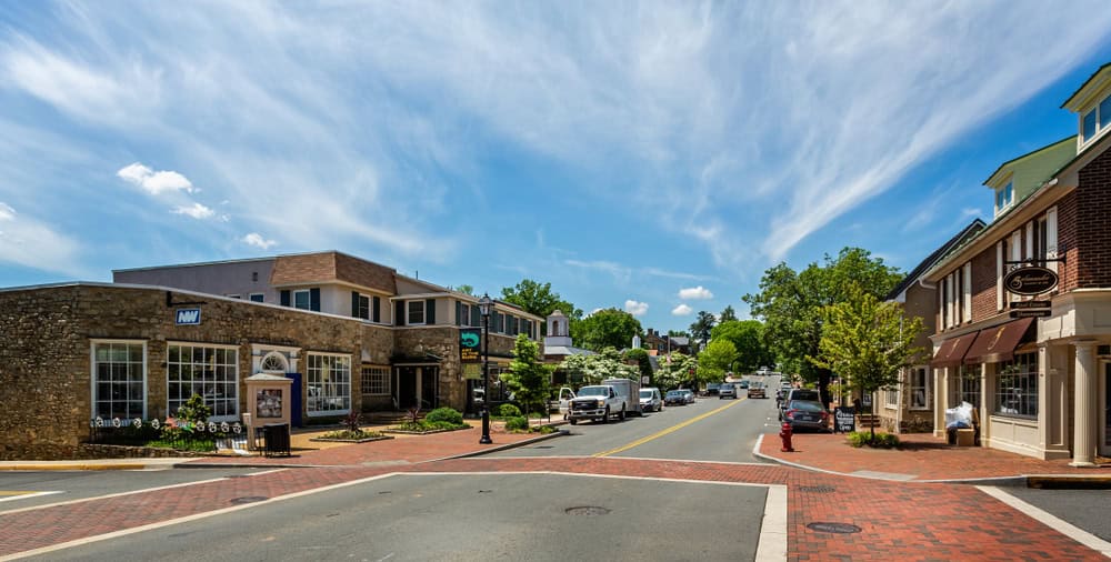 Stone and brick shopfronts line a quiet downtown street in Middleburg, Virginia