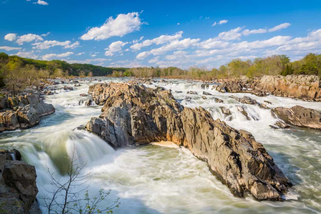 Powerful whitewater rapids over rocky ledges at Great Falls on the Potomac River in Great Falls, Virginia.