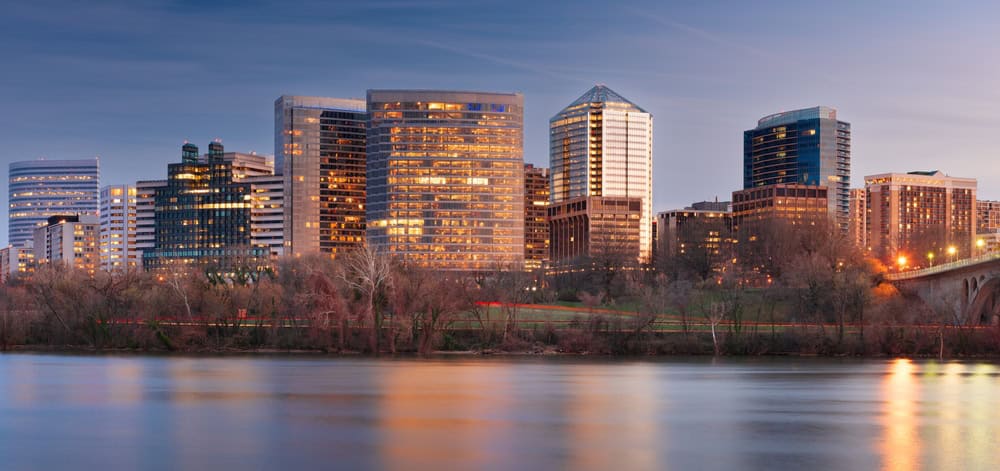 Downtown Rosslyn's high-rise skyline glows at dusk across the Potomac River in Arlington, Virginia