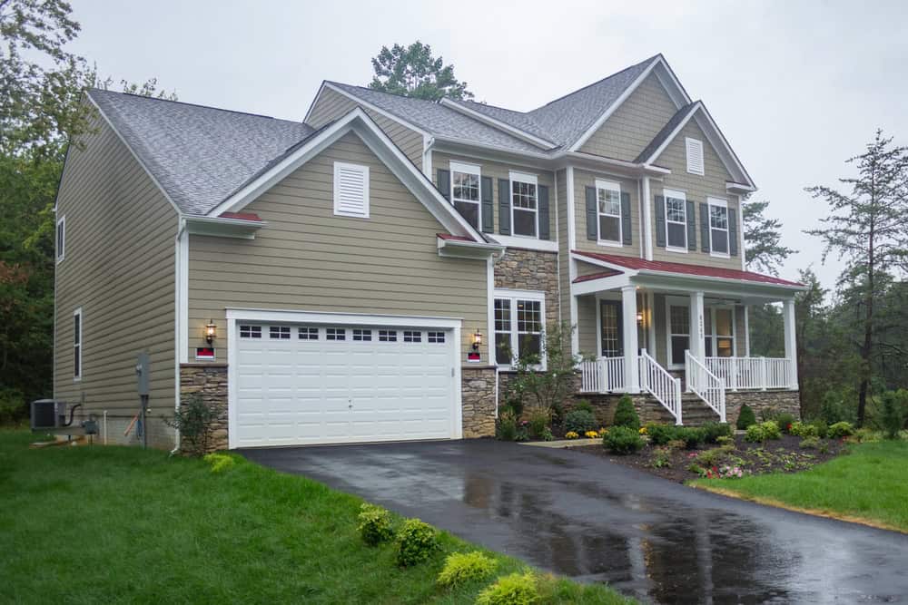 A two-story house with stone accents, a two-car garage, and a covered front porch in Vienna, Virginia.