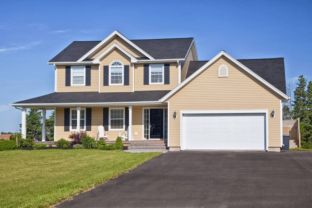 Detached home with an attached garage and front lawn