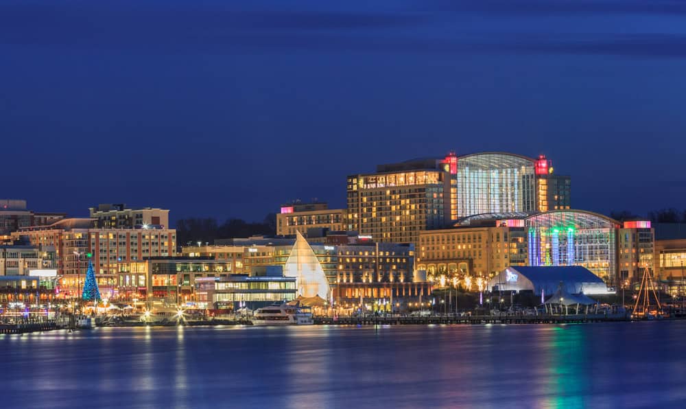 The illuminated National Harbor skyline reflected on the water at night, near Fort Washington, Maryland
