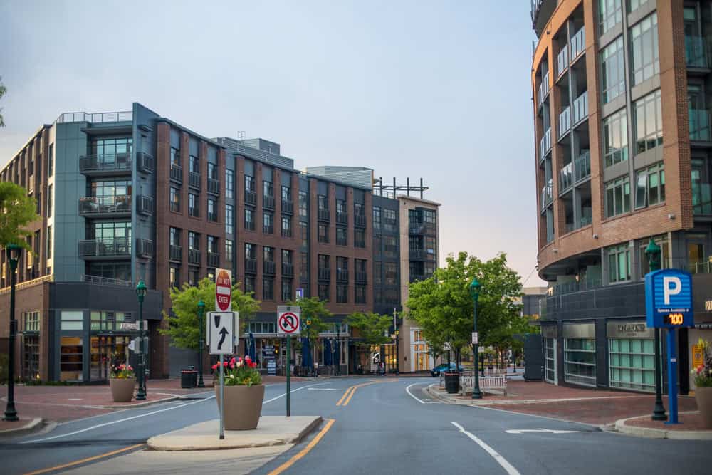 A downtown Bethesda street lined with brick apartment buildings and shops in Montgomery County, Maryland