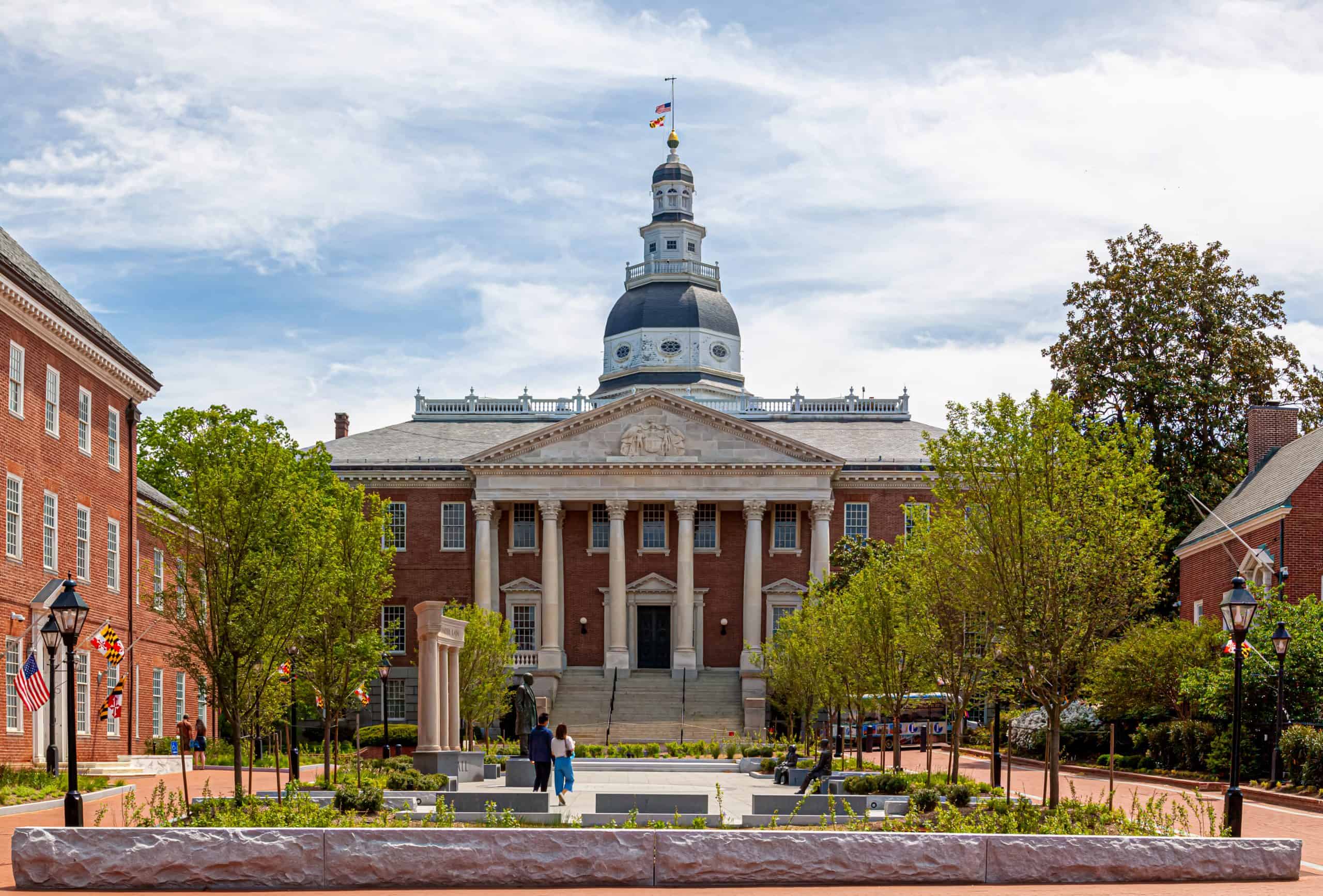 The Maryland State House with its white dome beyond a brick plaza.